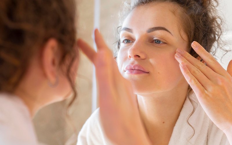 Woman looking into mirror